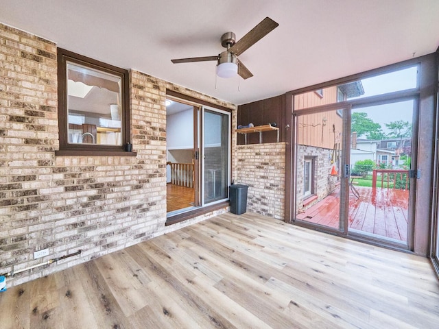 7201 W 110th St, Worth, IL 60482 - unfurnished living room featuring brick wall, wood finished floors, and ceiling fan