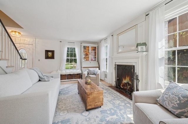 32 Valley Rd, Highland Park, IL 60035 - living area featuring stairway, a fireplace with flush hearth, and light wood-style flooring