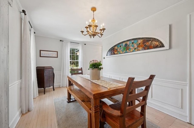 32 Valley Rd, Highland Park, IL 60035 - dining area with a chandelier, light wood finished floors, wainscoting, a decorative wall, and ornamental molding