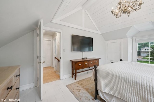 32 Valley Rd, Highland Park, IL 60035 - bedroom with vaulted ceiling, a chandelier, and light wood-style flooring