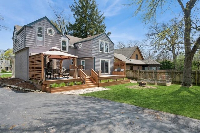 32 Valley Rd, Highland Park, IL 60035 - back of property featuring a gazebo, a deck, a fire pit, and brick siding