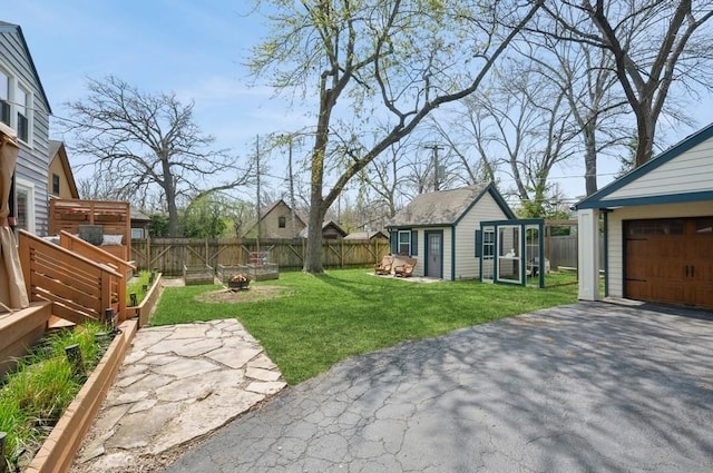 32 Valley Rd, Highland Park, IL 60035 - fenced backyard featuring an outdoor structure and asphalt driveway