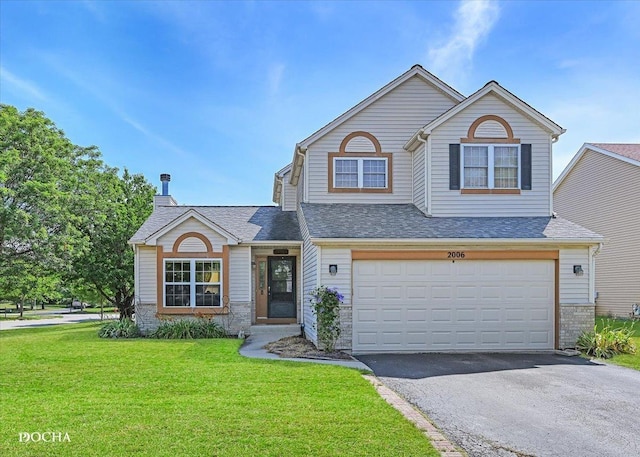 2006 Westmore Grove Dr, Plainfield, IL 60586 - traditional-style home featuring asphalt driveway, a front lawn, a garage, and a shingled roof