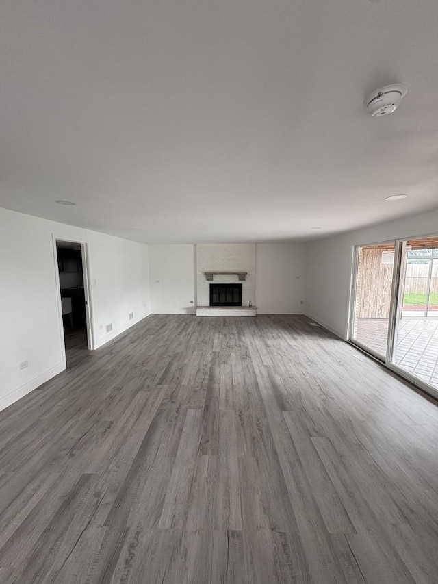 13623 S 84th Ave, Orland Park, IL 60462 - unfurnished living room featuring wood finished floors and a fireplace with raised hearth