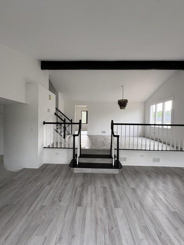13623 S 84th Ave, Orland Park, IL 60462 - unfurnished living room featuring wood finished floors, stairs, and a chandelier