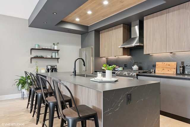1523 N Western Ave Unit 2A, Chicago, IL 60622 - kitchen with wall chimney range hood, modern cabinets, a raised ceiling, a breakfast bar, and recessed lighting