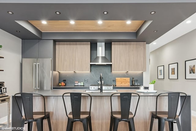 1523 N Western Ave Unit 2A, Chicago, IL 60622 - kitchen featuring wall chimney exhaust hood, modern cabinets, a raised ceiling, high end fridge, and recessed lighting