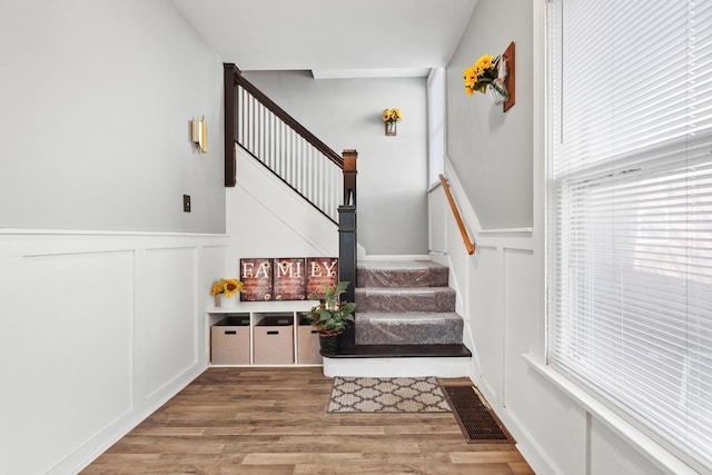 434 4th Ave, Joliet, IL 60433 - staircase with a decorative wall, wood finished floors, and a wainscoted wall