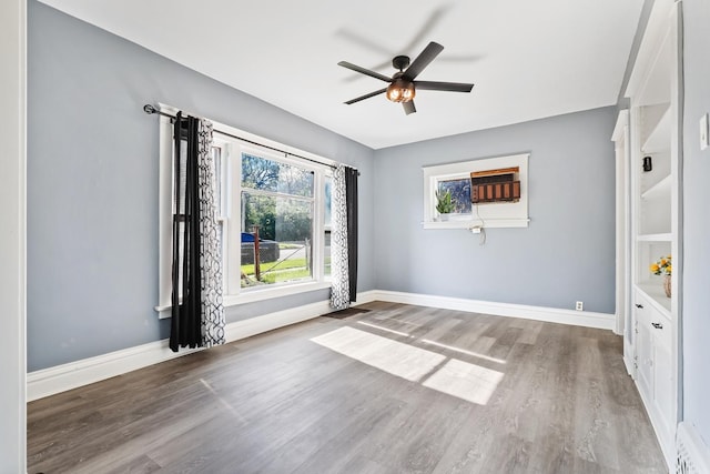 434 4th Ave, Joliet, IL 60433 - empty room featuring wood finished floors, ceiling fan, and a wall mounted AC