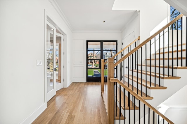 1206 Isabella St, Wilmette, IL 60091 - entrance foyer featuring light wood-style flooring, ornamental molding, and stairs