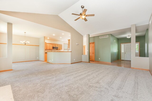313 W Burlington Dr, Maple Park, IL 60151 - unfurnished living room featuring light carpet, a ceiling fan, a chandelier, and high vaulted ceiling