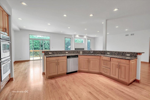 3550 E Ari Dr, Glenview, IL 60025 - kitchen with appliances with stainless steel finishes, light wood finished floors, recessed lighting, light brown cabinets, and dark stone counters