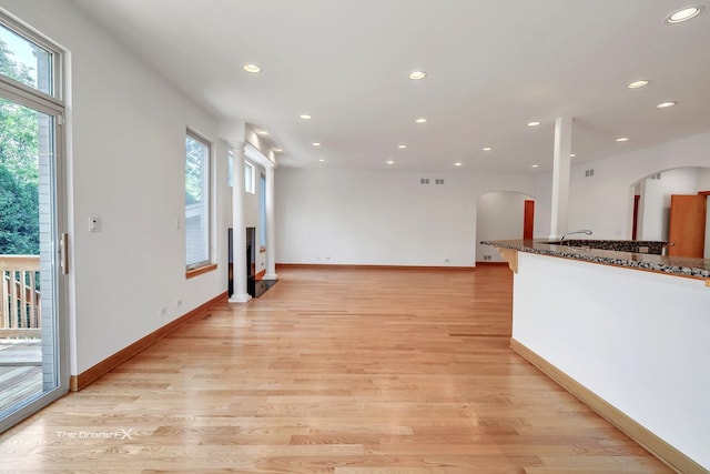 3550 E Ari Dr, Glenview, IL 60025 - unfurnished living room with arched walkways, healthy amount of natural light, recessed lighting, and light wood finished floors