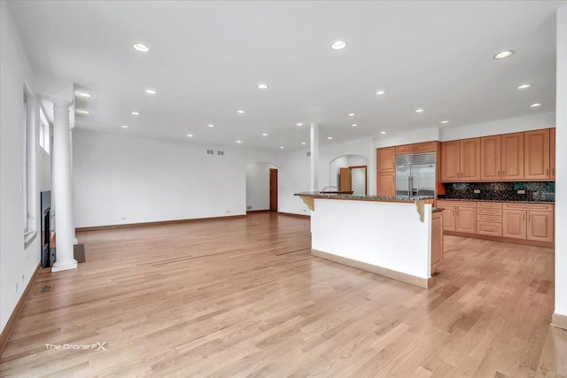 3550 E Ari Dr, Glenview, IL 60025 - kitchen with built in refrigerator, arched walkways, recessed lighting, backsplash, and light wood-style flooring