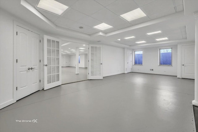 3550 E Ari Dr, Glenview, IL 60025 - empty room with french doors, finished concrete flooring, a raised ceiling, and a paneled ceiling