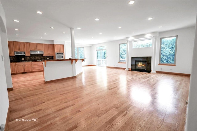 3550 E Ari Dr, Glenview, IL 60025 - kitchen featuring stainless steel appliances, a breakfast bar area, recessed lighting, under cabinet range hood, and dark countertops