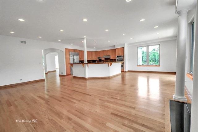 3550 E Ari Dr, Glenview, IL 60025 - unfurnished living room featuring recessed lighting, arched walkways, and light wood finished floors