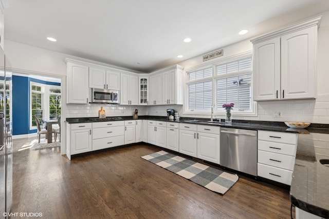 1000 S Madison Ave, La Grange, IL 60525 - kitchen featuring appliances with stainless steel finishes, white cabinets, decorative backsplash, dark wood-style flooring, and recessed lighting