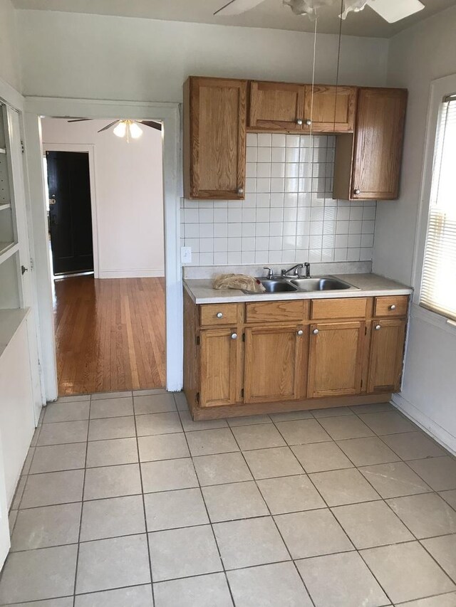kitchen featuring a ceiling fan, light countertops, and brown cabinets