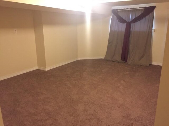 basement featuring carpet and baseboards