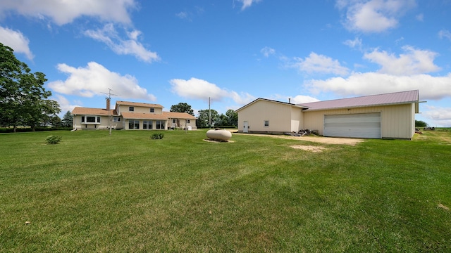 10245 W Penn Cor, Polo, IL 61064 - rear view of house featuring a yard, driveway, and a metal roof