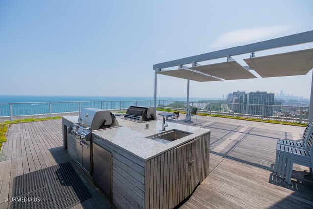 3900 N Lake Shore Dr Unit 3E, Chicago, IL 60613 - wooden deck featuring an outdoor kitchen and a water view