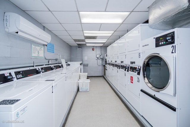 3900 N Lake Shore Dr Unit 3E, Chicago, IL 60613 - shared laundry room with estacked washer and dryer, separate washer and dryer, a wall mounted air conditioner, and concrete block wall