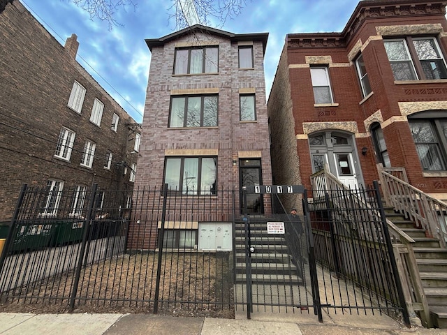 1017 S Claremont Ave, Chicago, IL 60612 - view of front of house with a fenced front yard, brick siding, and a gate