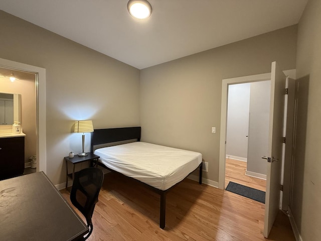 1017 S Claremont Ave, Chicago, IL 60612 - bedroom with light wood-style floors and connected bathroom