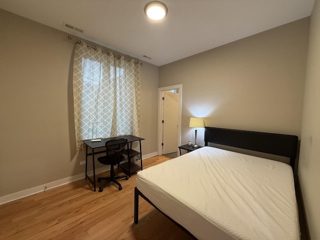 1017 S Claremont Ave, Chicago, IL 60612 - bedroom with light wood-style flooring and baseboards
