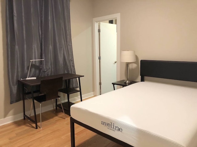 1017 S Claremont Ave, Chicago, IL 60612 - bedroom with light wood-style floors and baseboards