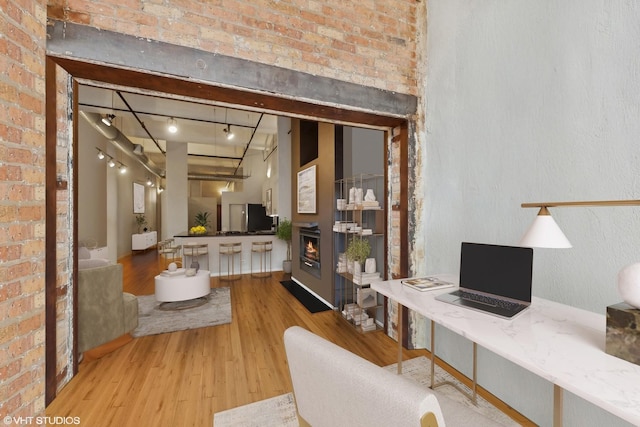 1000 W Washington Blvd Unit 320, Chicago, IL 60607 - office area with wood finished floors, brick wall, a lit fireplace, and rail lighting