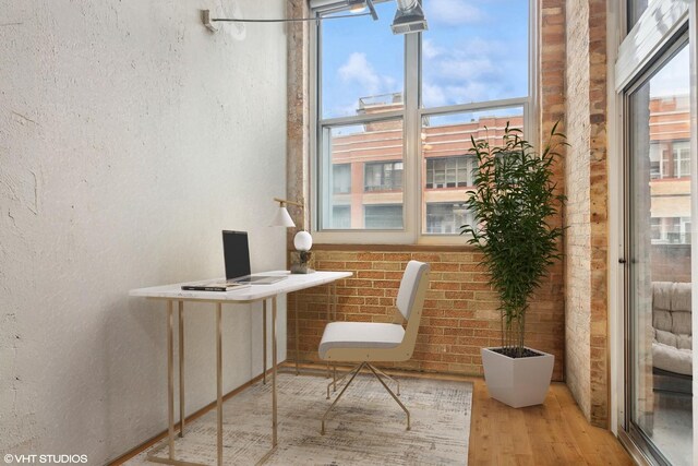 1000 W Washington Blvd Unit 320, Chicago, IL 60607 - home office with wood finished floors and a textured wall