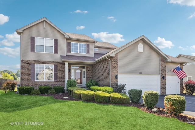 1581 Kenmore Ave, Aurora, IL 60505 - traditional home with brick siding, a garage, driveway, and a front yard