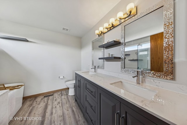 1581 Kenmore Ave, Aurora, IL 60505 - bathroom with double vanity, wood finished floors, and an enclosed shower