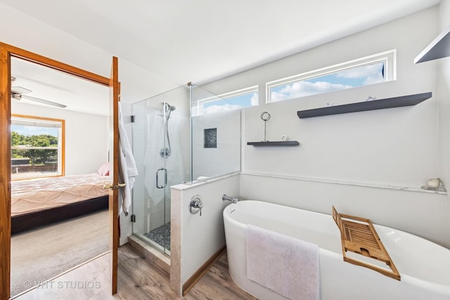 1581 Kenmore Ave, Aurora, IL 60505 - full bathroom featuring wood finished floors, a shower stall, a freestanding bath, and connected bathroom