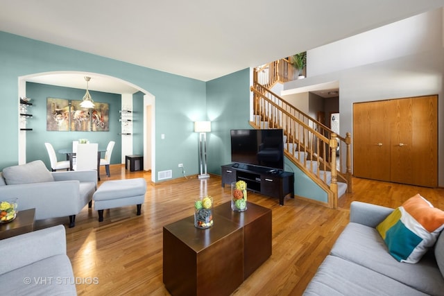 1581 Kenmore Ave, Aurora, IL 60505 - living room with stairs, arched walkways, and wood finished floors