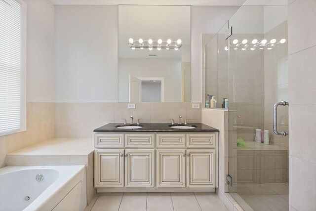 3126 W Walton St Unit 2, Chicago, IL 60622 - bathroom with a shower stall, double vanity, a tub with jets, and tile patterned floors
