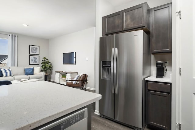 2621 Harnish Dr, Algonquin, IL 60102 - kitchen with stainless steel fridge, dark brown cabinets, dark wood-style floors, open floor plan, and light stone countertops