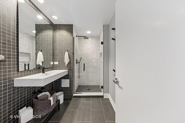 130 N Garland Ct Unit 2612, Chicago, IL 60602 - full bathroom featuring a stall shower, recessed lighting, and tile walls