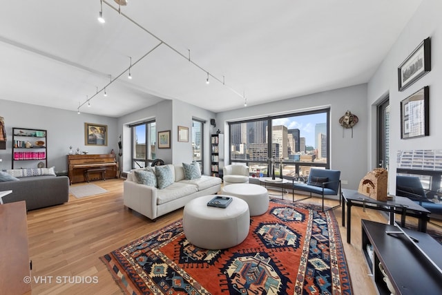 130 N Garland Ct Unit 2612, Chicago, IL 60602 - living area featuring rail lighting, light wood-style floors, and a view of city