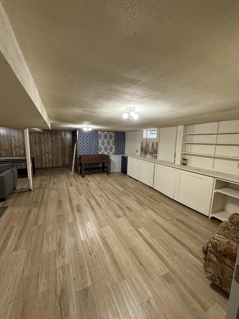 1369 Superior Ave, Calumet City, IL 60409 - below grade area with a textured ceiling and light wood-style floors