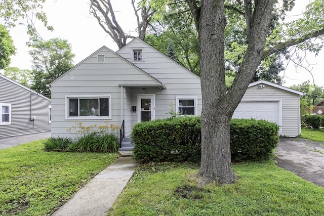 221 Kenwood Dr, Round Lake Park, IL 60073 - view of front of property with a front lawn, asphalt driveway, an outbuilding, and a garage