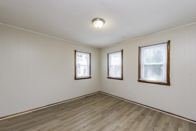 221 Kenwood Dr, Round Lake Park, IL 60073 - empty room featuring light wood-style flooring and crown molding