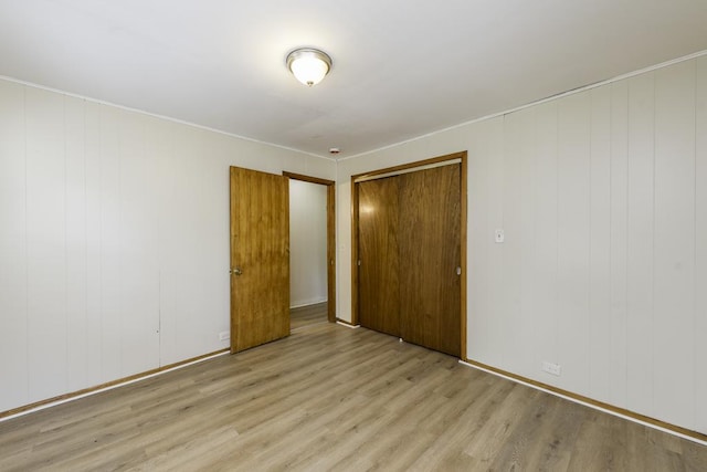 221 Kenwood Dr, Round Lake Park, IL 60073 - unfurnished bedroom with light wood-style floors and a closet