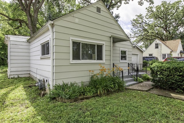 221 Kenwood Dr, Round Lake Park, IL 60073 - rear view of house featuring a yard