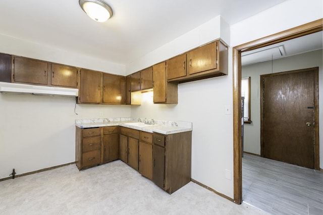 221 Kenwood Dr, Round Lake Park, IL 60073 - kitchen with under cabinet range hood, light countertops, and brown cabinetry