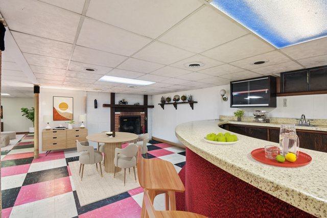 1745 Lyndale Rd, Aurora, IL 60506 - kitchen featuring tile patterned floors, a fireplace, a paneled ceiling, and open floor plan