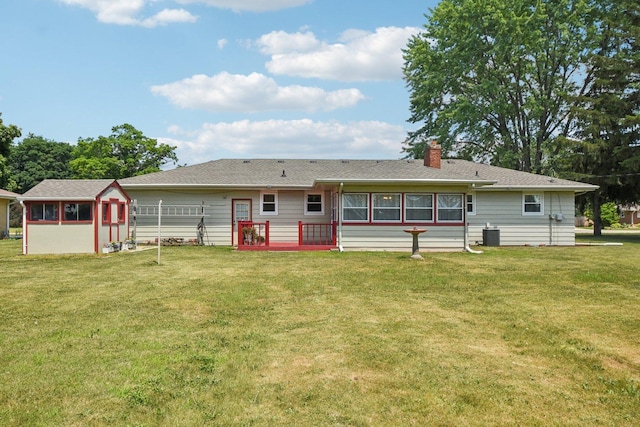 1745 Lyndale Rd, Aurora, IL 60506 - back of house with a chimney, a lawn, and a shed