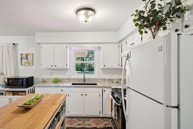 1745 Lyndale Rd, Aurora, IL 60506 - kitchen with freestanding refrigerator, gas stove, white cabinets, black microwave, and butcher block counters